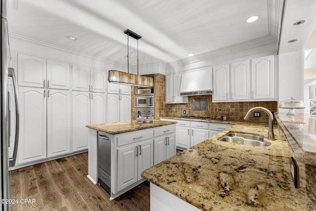 kitchen featuring premium range hood, pendant lighting, sink, appliances with stainless steel finishes, and white cabinets