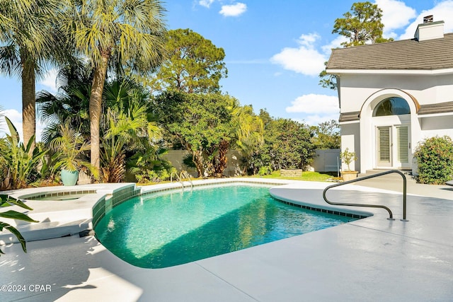 view of pool with a patio area and an in ground hot tub