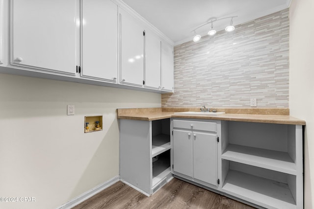 washroom with washer hookup, dark wood-type flooring, cabinets, and sink