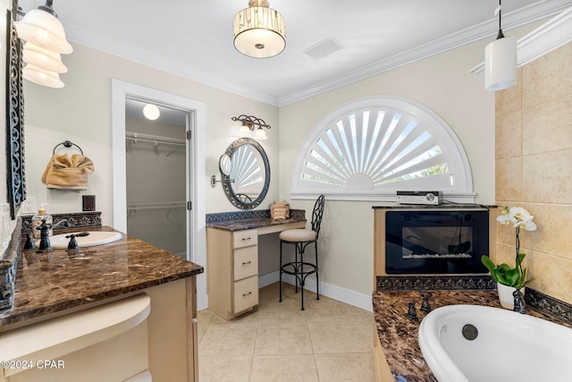 bathroom with tile patterned floors, vanity, ornamental molding, and a tub to relax in