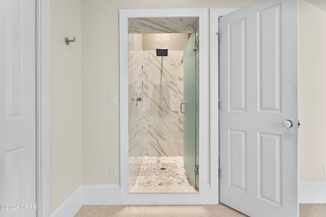 bathroom featuring a shower with door and tile patterned flooring