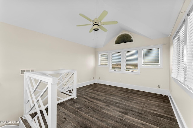 unfurnished room featuring vaulted ceiling, ceiling fan, and dark hardwood / wood-style flooring