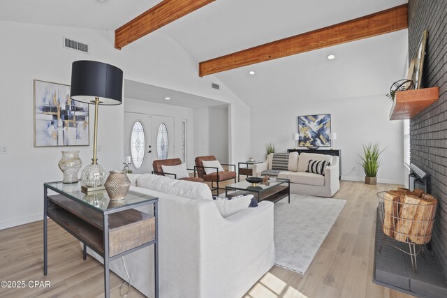 living room with light wood finished floors, recessed lighting, visible vents, lofted ceiling with beams, and baseboards