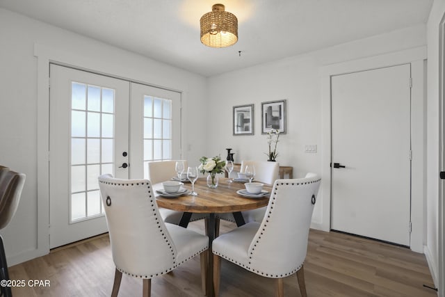 dining room with wood finished floors and french doors