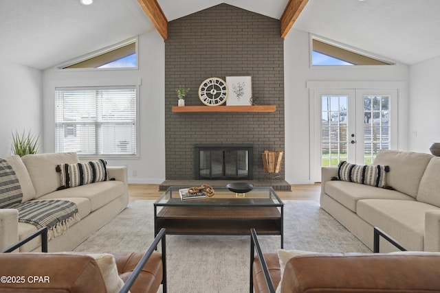 living room with a wealth of natural light, a fireplace, vaulted ceiling with beams, and wood finished floors