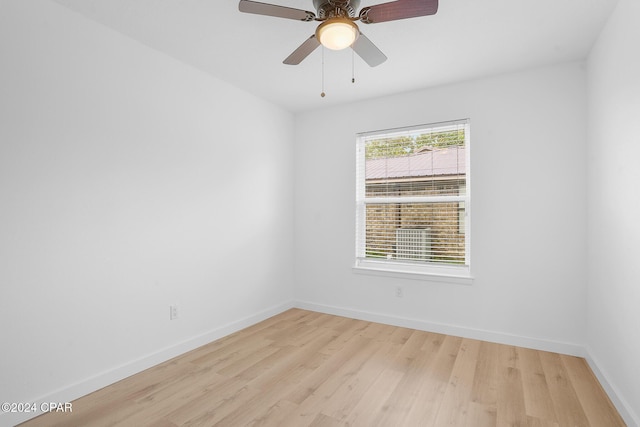 spare room with light wood-style flooring, baseboards, and ceiling fan