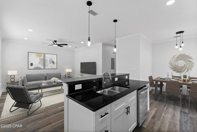 kitchen with dark stone counters, white cabinetry, crown molding, and stainless steel appliances