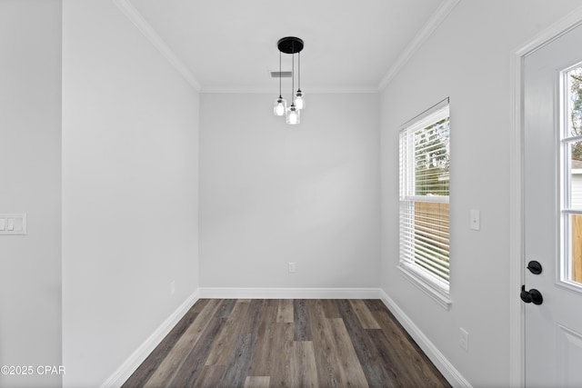 unfurnished dining area featuring crown molding, dark wood-type flooring, and a wealth of natural light