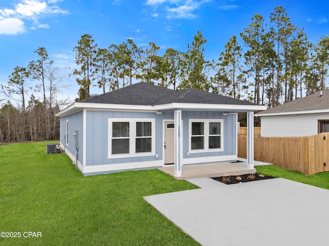 exterior space featuring a front lawn, a patio area, and central air condition unit