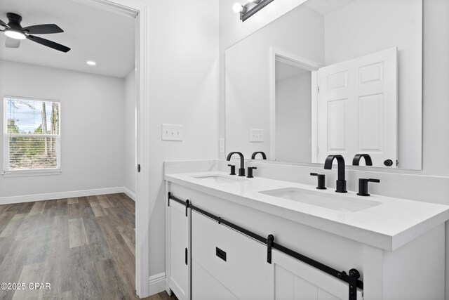 bathroom with a shower, toilet, vanity, and hardwood / wood-style flooring