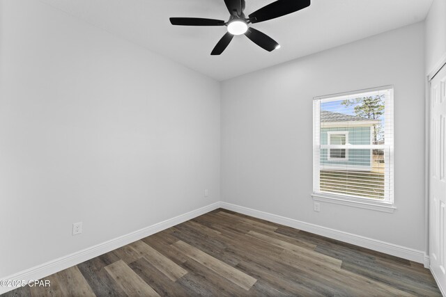 spare room featuring ceiling fan and dark hardwood / wood-style floors