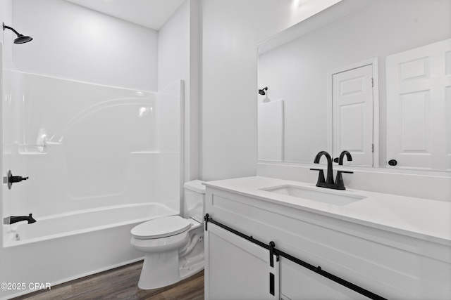 full bathroom with hardwood / wood-style flooring,  shower combination, toilet, and vanity