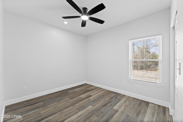 spare room featuring ceiling fan and dark hardwood / wood-style flooring