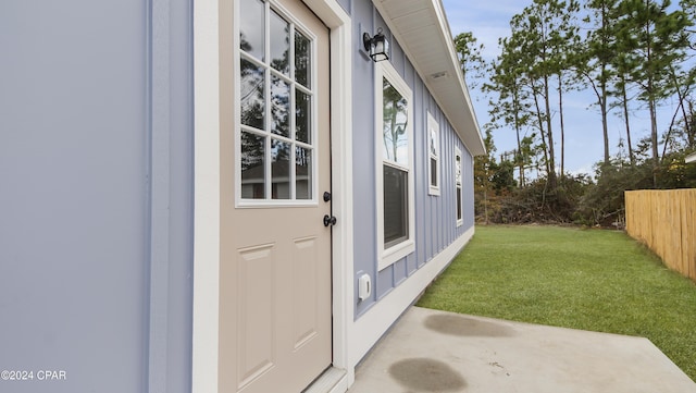 doorway to property with a lawn