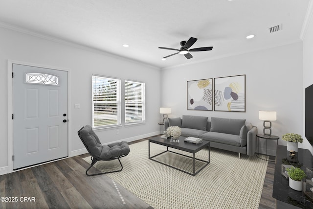 living room with ornamental molding, dark hardwood / wood-style floors, and ceiling fan