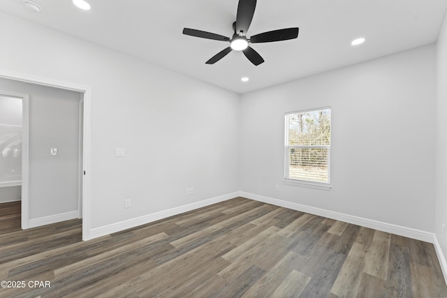 spare room with dark hardwood / wood-style floors and ceiling fan