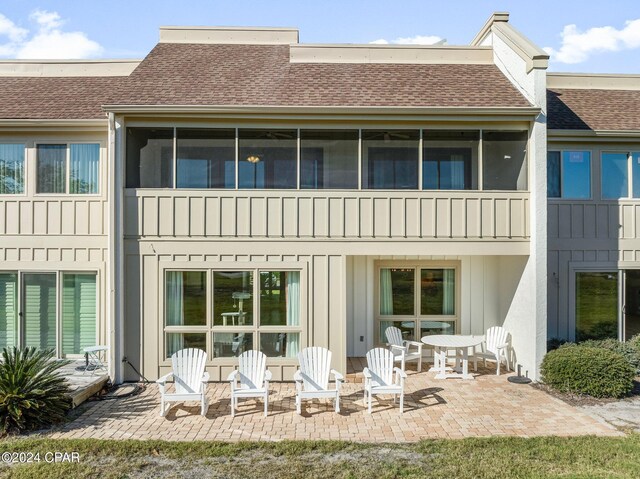 rear view of property featuring a balcony and a patio