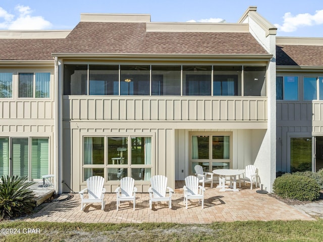 4301 Bay Point Rd Unit 479, Panama City Beach, FL 32408 - rear view of property with a sunroom, roof with shingles, board and batten siding, and a patio