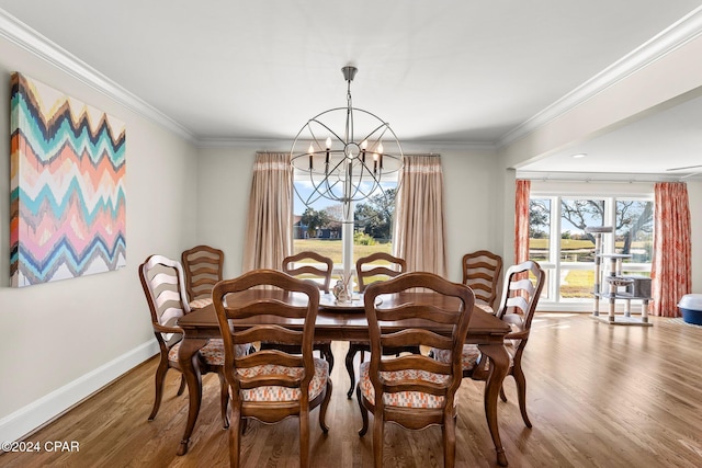 dining space with ornamental molding, a chandelier, baseboards, and wood finished floors