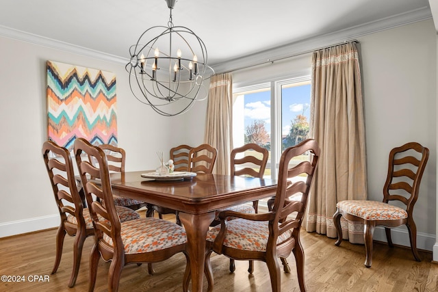 4301 Bay Point Rd Unit 479, Panama City Beach, FL 32408 - dining room with light wood-type flooring, crown molding, baseboards, and an inviting chandelier