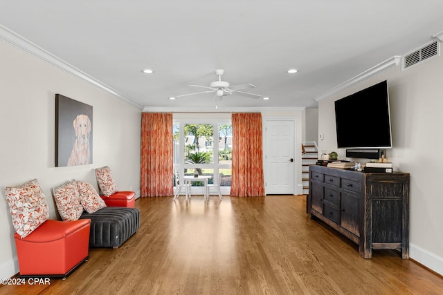 living room with ceiling fan, light hardwood / wood-style flooring, and ornamental molding