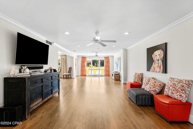 living room featuring hardwood / wood-style flooring, ceiling fan, and ornamental molding