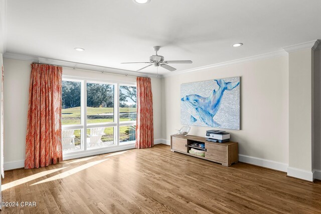 unfurnished living room featuring hardwood / wood-style floors, ceiling fan, and crown molding