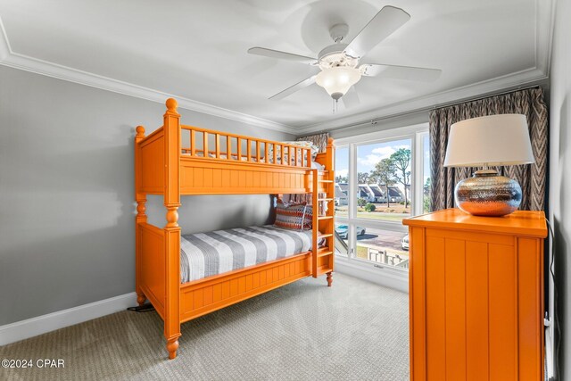 bedroom featuring ceiling fan, crown molding, and carpet