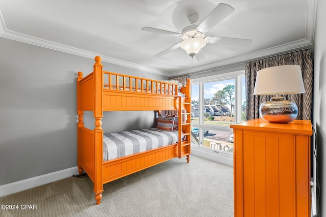 bedroom featuring a ceiling fan, carpet flooring, crown molding, and baseboards