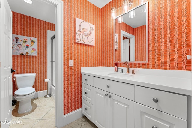 full bathroom with toilet, vanity, tile patterned floors, and enclosed tub / shower combo