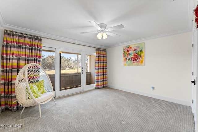 unfurnished room with ornamental molding, carpet, a ceiling fan, and baseboards