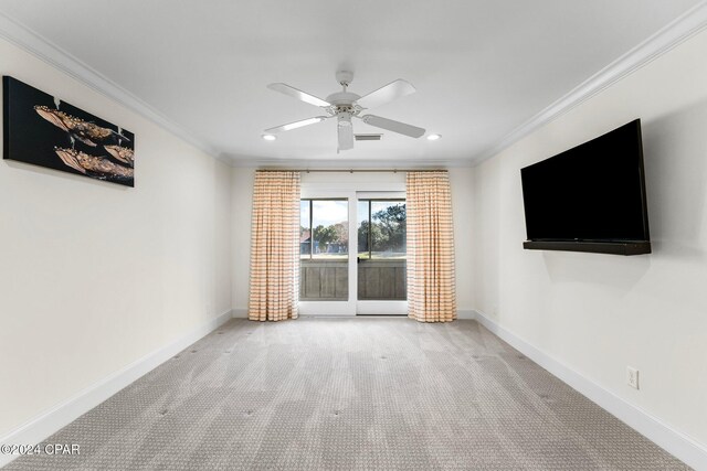 interior space with ceiling fan, light colored carpet, and crown molding