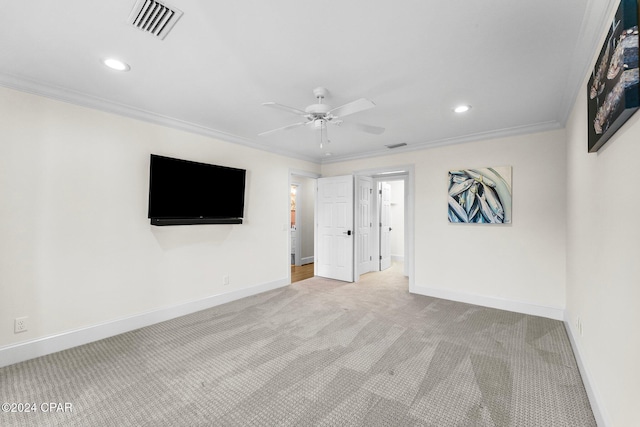 carpeted empty room featuring ceiling fan and crown molding