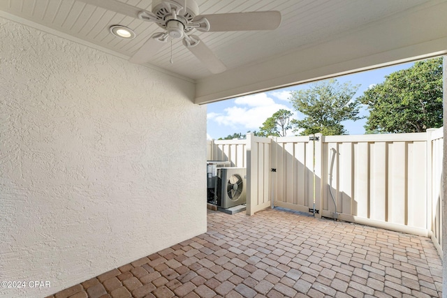 view of patio featuring ac unit, a gate, fence, and a ceiling fan