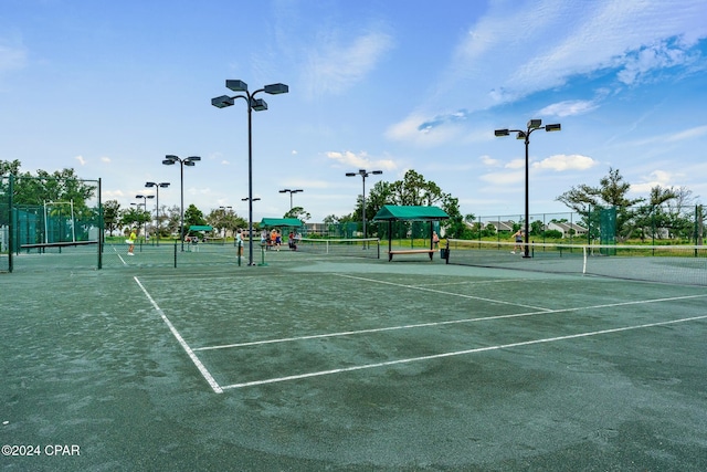 view of sport court featuring fence