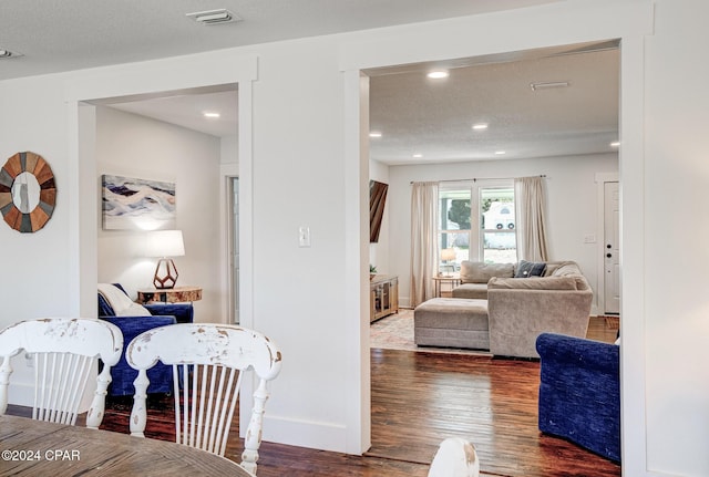 living room featuring dark hardwood / wood-style flooring and a textured ceiling