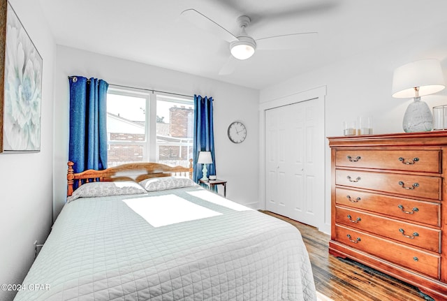 bedroom with ceiling fan, wood-type flooring, and a closet