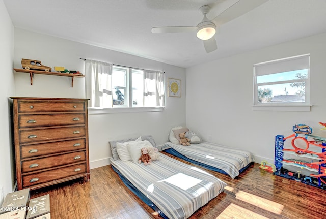 bedroom with hardwood / wood-style floors and ceiling fan