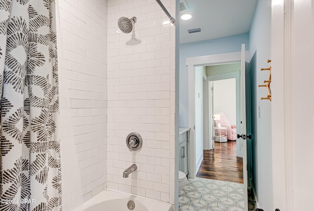 bathroom with wood-type flooring, toilet, and shower / bath combo