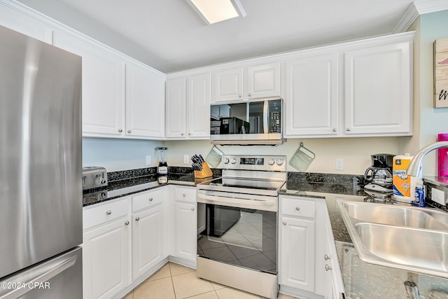 kitchen featuring white cabinetry, sink, stainless steel appliances, and light tile patterned flooring