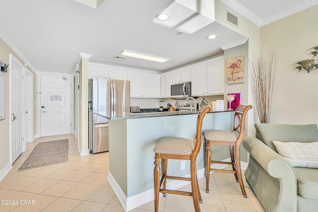 15817 Front Beach Rd Unit 1-1505, Panama City Beach, FL 32413 - kitchen with a kitchen breakfast bar, stainless steel appliances, white cabinetry, a peninsula, and visible vents