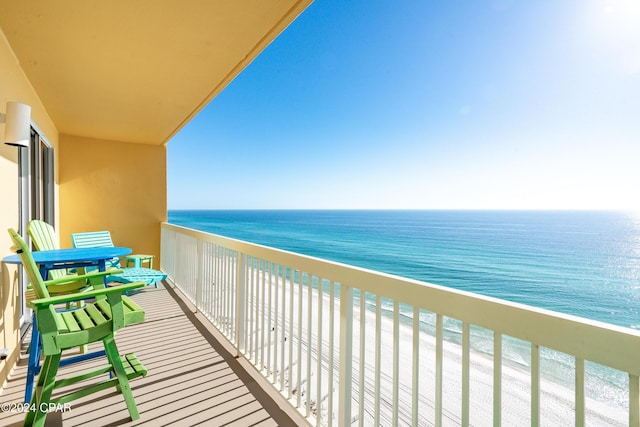 balcony with a water view and a beach view