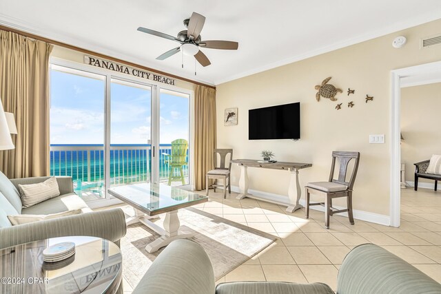 tiled living room featuring a water view, ceiling fan, and crown molding