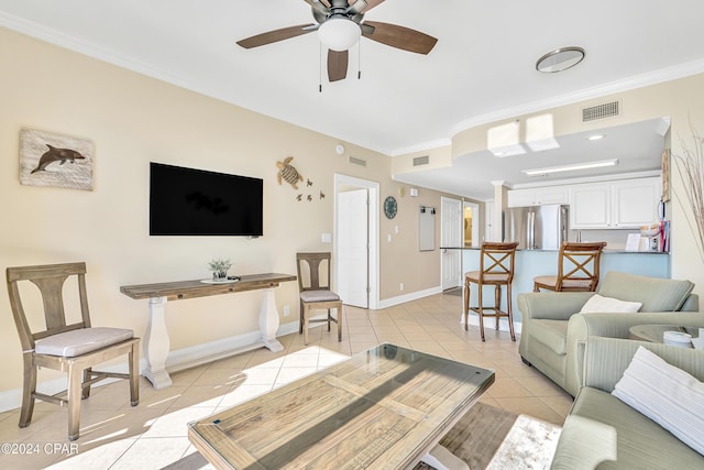 living room with ceiling fan, light tile patterned flooring, and ornamental molding