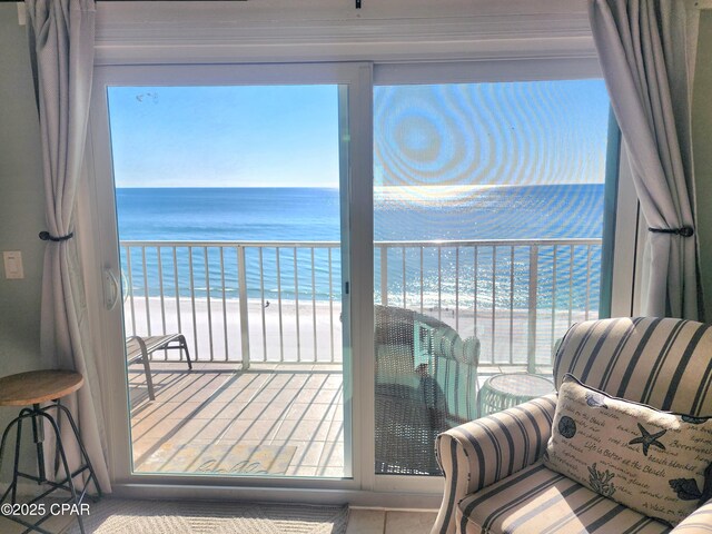 balcony featuring a beach view and a water view