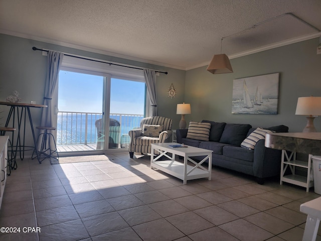 living room with a textured ceiling, ornamental molding, tile patterned flooring, and a water view