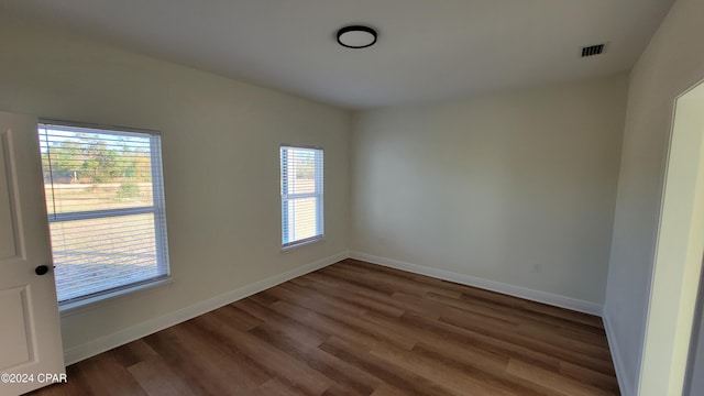 spare room with dark hardwood / wood-style floors