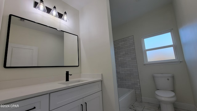 full bathroom with vanity, tiled shower / bath, and toilet