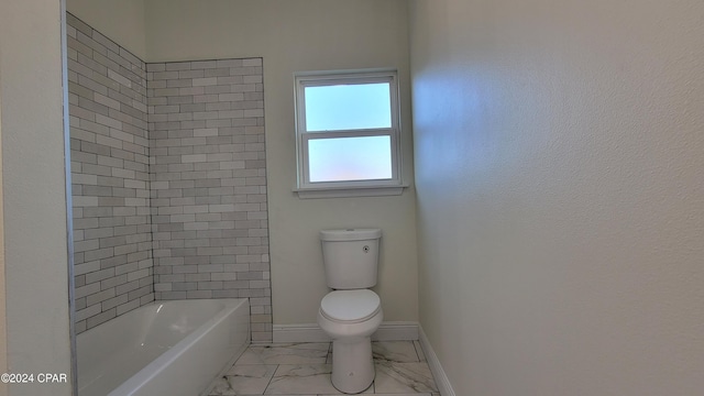 bathroom featuring toilet and tiled shower / bath combo