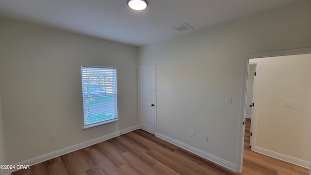 spare room with light hardwood / wood-style floors